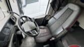 Volvo FH truck cabin with ergonomic driver seat and dashboard.